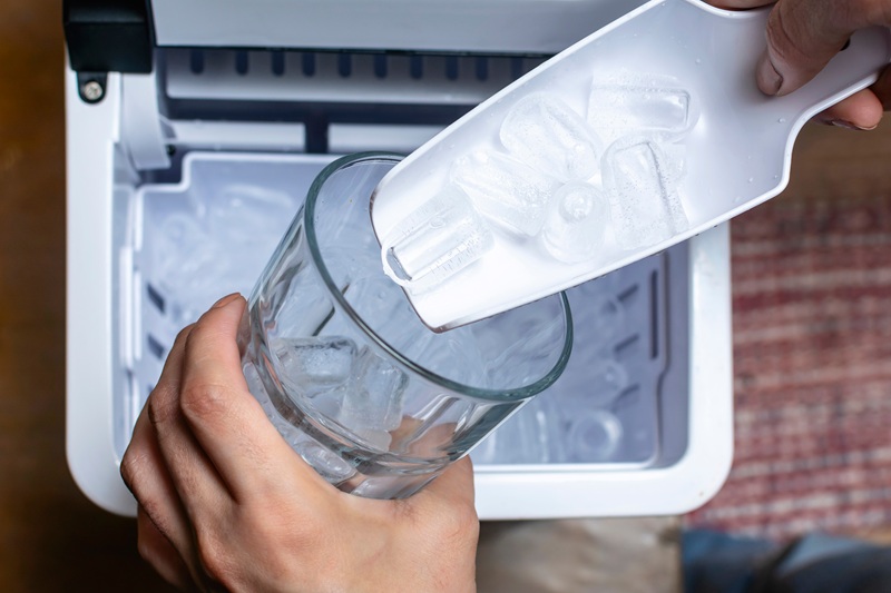 scooping ice from portable ice machine